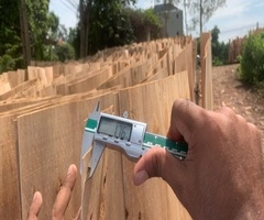 Vifuko quality control inspecting eucalyptus core veneer thickness with digital caliper in Vietnam